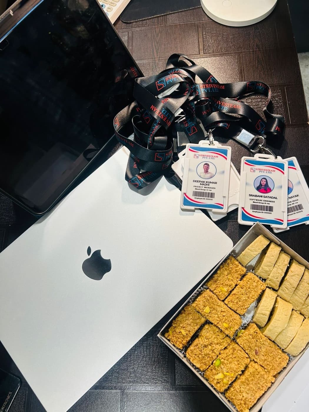 New-joiner welcome kit with laptop and ID badges